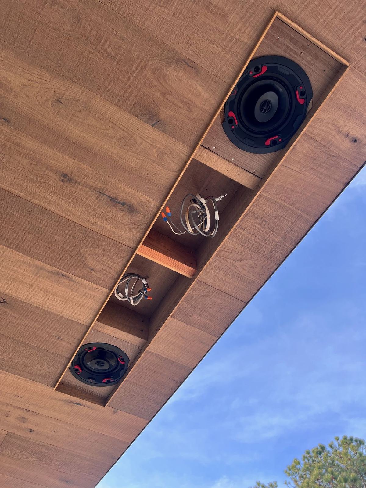 Speakers recessed into a wood soffit on a Hamptons home