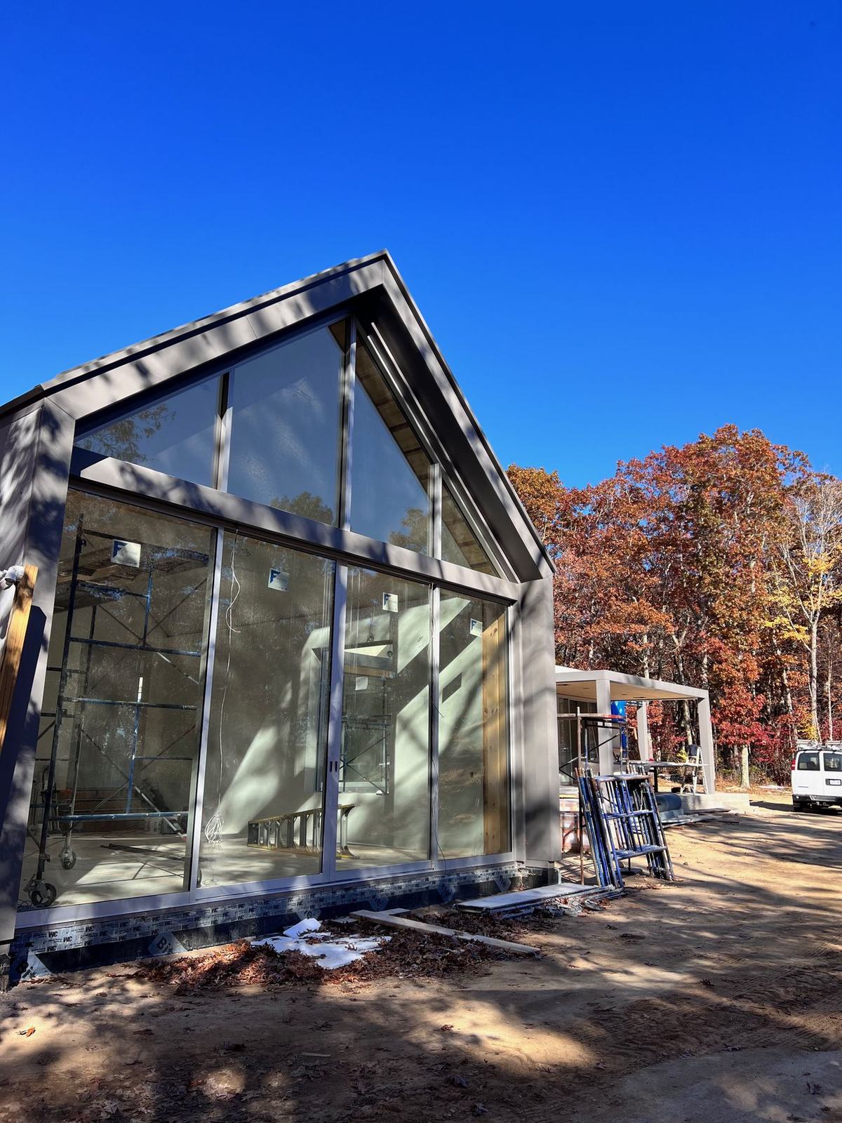 Modern glass-gabled new-construction home in Water Mill, NY, pre-wired by HamptonTek